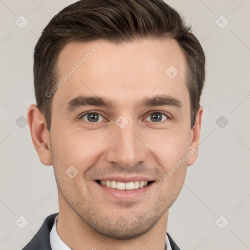 Joyful white young-adult male with short  brown hair and grey eyes