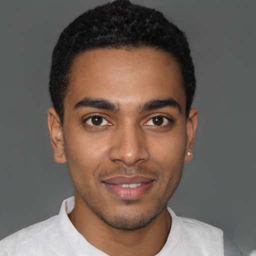 Joyful black young-adult male with short  black hair and brown eyes