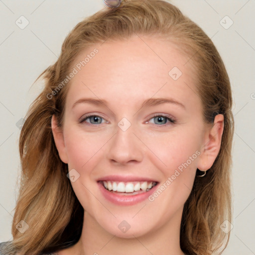 Joyful white young-adult female with long  brown hair and blue eyes