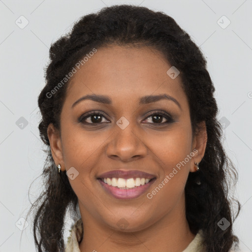 Joyful black young-adult female with long  brown hair and brown eyes