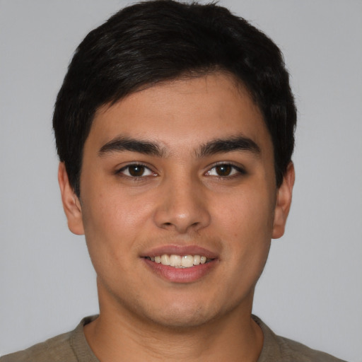 Joyful latino young-adult male with short  brown hair and brown eyes