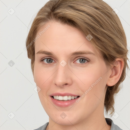 Joyful white young-adult female with medium  brown hair and grey eyes