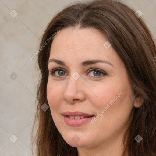 Joyful white young-adult female with long  brown hair and green eyes