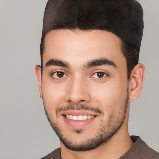 Joyful white young-adult male with short  black hair and brown eyes