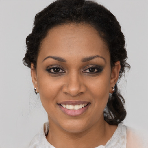 Joyful black young-adult female with medium  brown hair and brown eyes