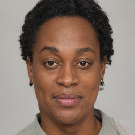 Joyful black adult female with short  brown hair and brown eyes