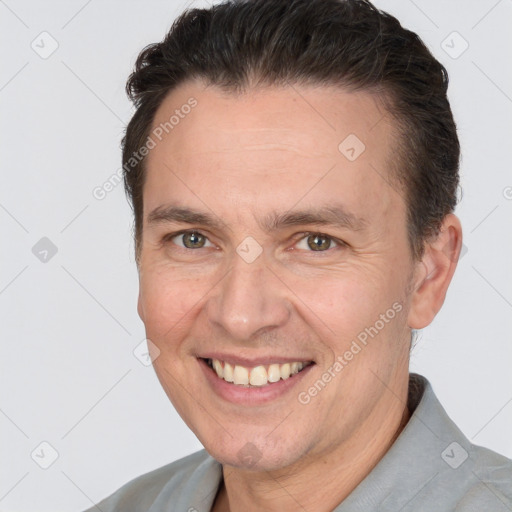 Joyful white adult male with short  brown hair and brown eyes