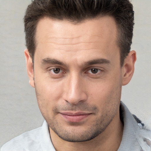 Joyful white young-adult male with short  brown hair and brown eyes