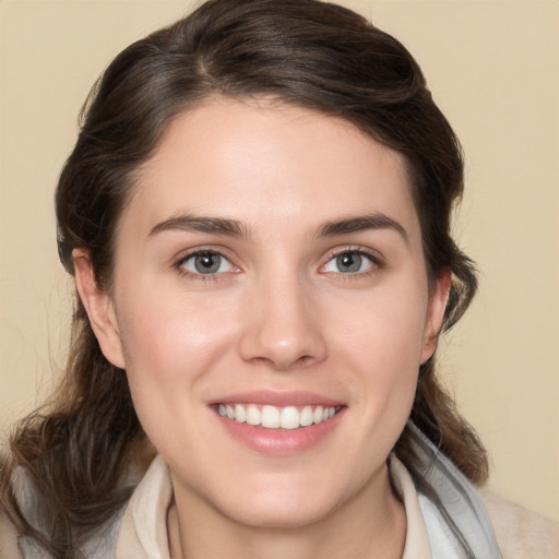 Joyful white young-adult female with medium  brown hair and brown eyes