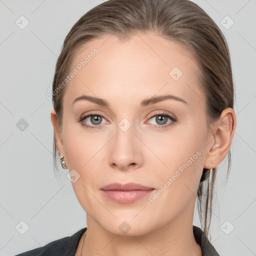 Joyful white young-adult female with medium  brown hair and grey eyes