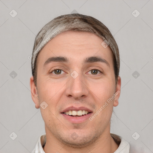 Joyful white young-adult male with short  black hair and brown eyes