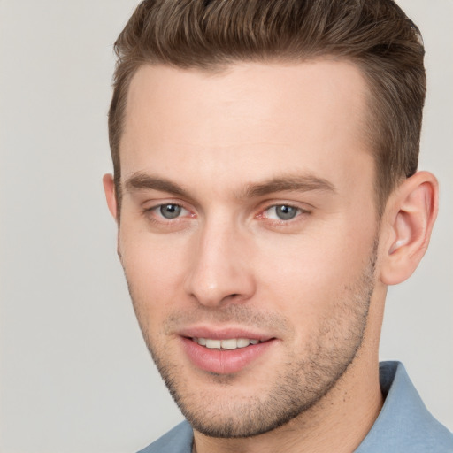 Joyful white young-adult male with short  brown hair and brown eyes