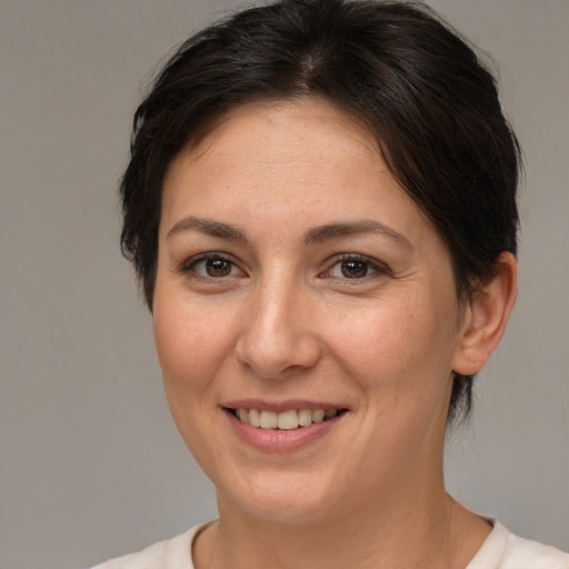 Joyful white adult female with short  brown hair and brown eyes