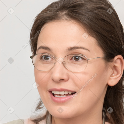 Joyful white adult female with medium  brown hair and grey eyes