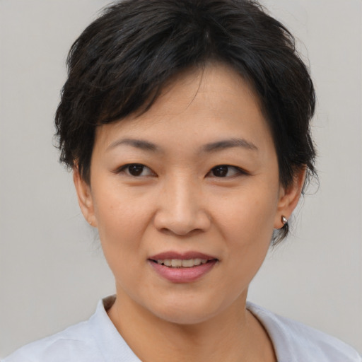 Joyful asian young-adult female with short  brown hair and brown eyes