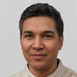 Joyful white adult male with short  black hair and brown eyes