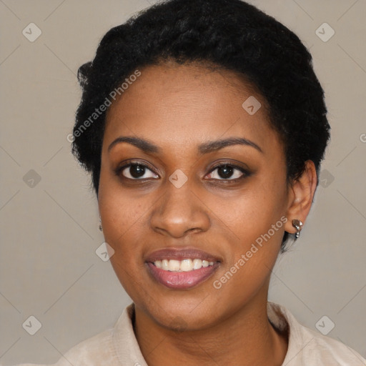 Joyful black young-adult female with short  black hair and brown eyes