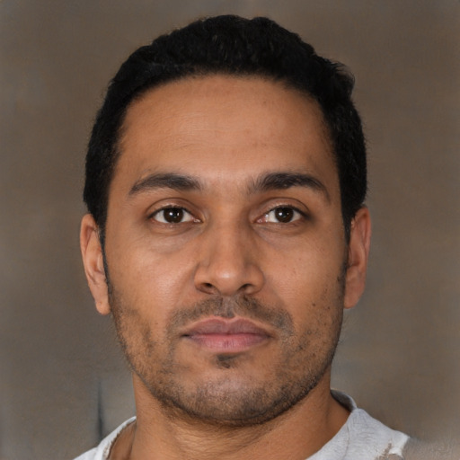 Neutral latino young-adult male with short  black hair and brown eyes