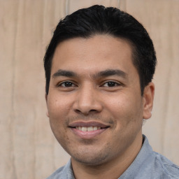 Joyful asian young-adult male with short  black hair and brown eyes