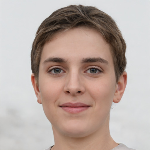 Joyful white young-adult female with short  brown hair and grey eyes