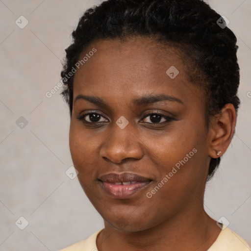 Joyful black young-adult female with short  black hair and brown eyes