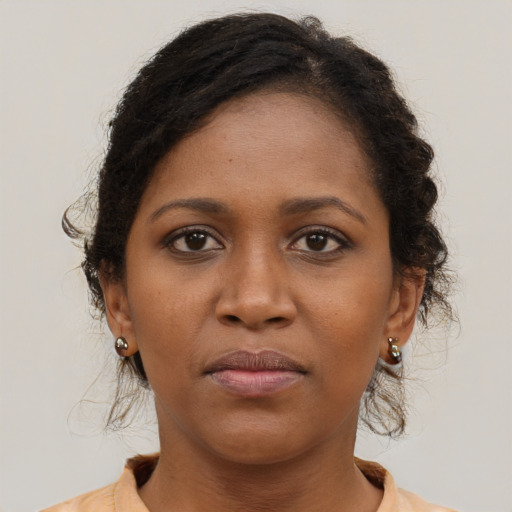Neutral black young-adult female with long  brown hair and brown eyes