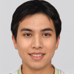 Joyful asian young-adult male with short  brown hair and brown eyes