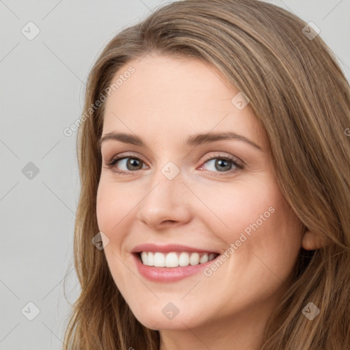 Joyful white young-adult female with long  brown hair and green eyes