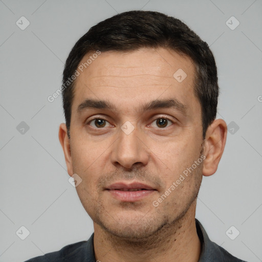 Joyful white young-adult male with short  black hair and brown eyes