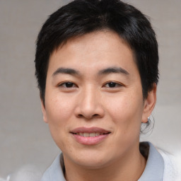 Joyful asian young-adult male with short  black hair and brown eyes