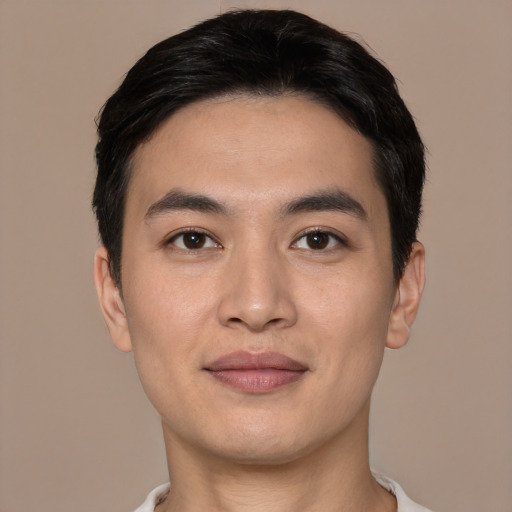 Joyful white young-adult male with short  black hair and brown eyes