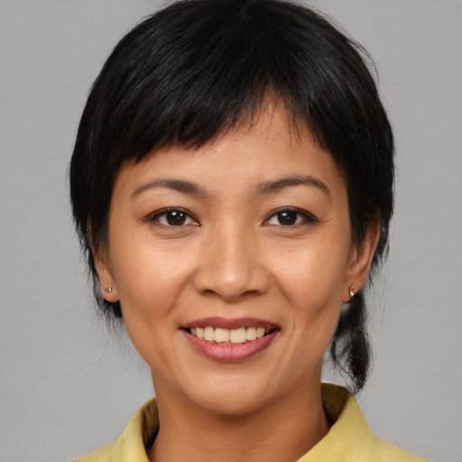 Joyful white young-adult female with medium  black hair and brown eyes