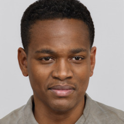 Joyful black young-adult male with short  brown hair and brown eyes