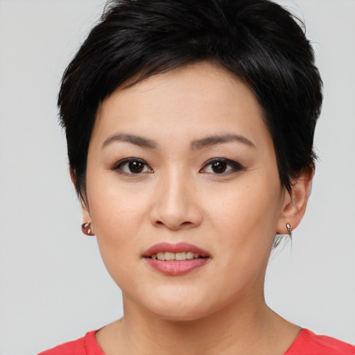 Joyful asian young-adult female with short  black hair and brown eyes