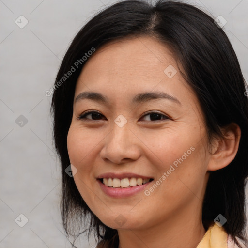 Joyful asian young-adult female with medium  brown hair and brown eyes