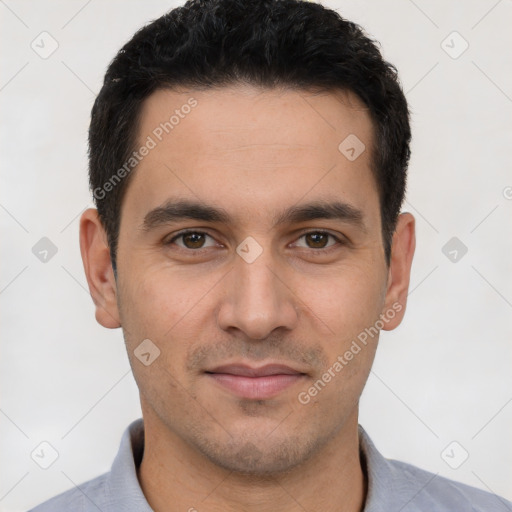 Joyful white young-adult male with short  black hair and brown eyes