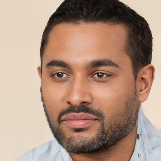 Joyful latino young-adult male with short  black hair and brown eyes