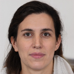 Joyful white adult female with medium  brown hair and brown eyes