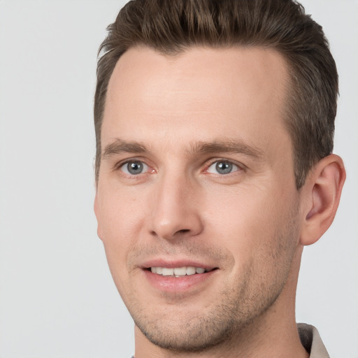 Joyful white young-adult male with short  brown hair and brown eyes