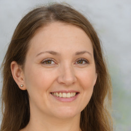 Joyful white adult female with long  brown hair and brown eyes