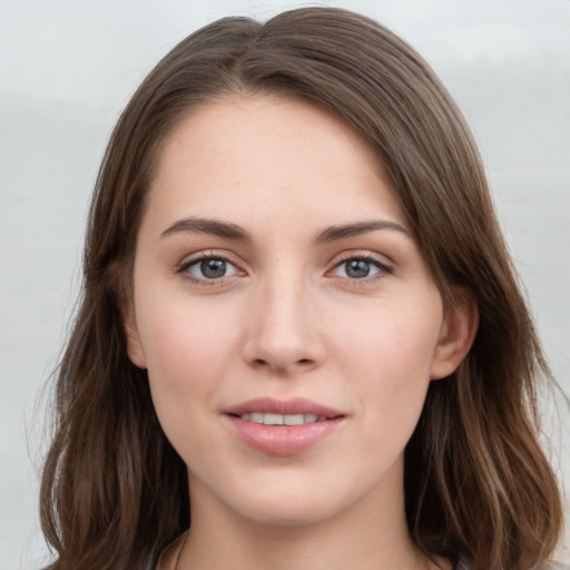 Joyful white young-adult female with long  brown hair and grey eyes