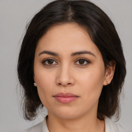 Joyful white young-adult female with medium  brown hair and brown eyes