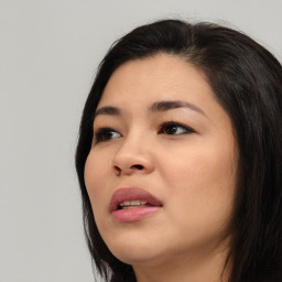 Joyful asian young-adult female with long  brown hair and brown eyes