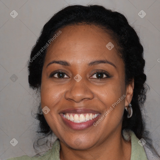 Joyful black adult female with medium  black hair and brown eyes