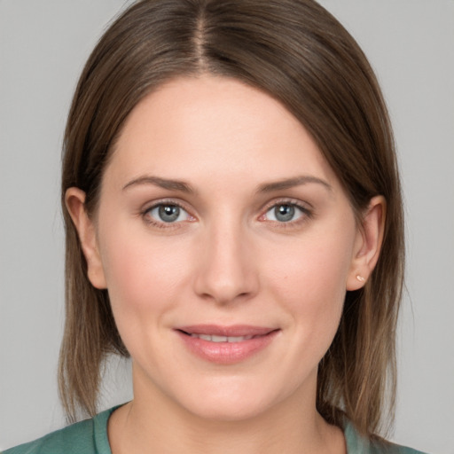 Joyful white young-adult female with medium  brown hair and grey eyes