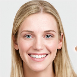 Joyful white young-adult female with long  brown hair and blue eyes