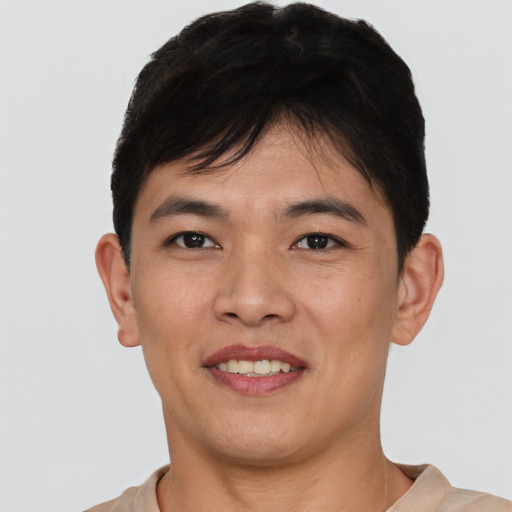 Joyful white young-adult male with short  black hair and brown eyes