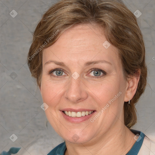 Joyful white adult female with medium  brown hair and blue eyes