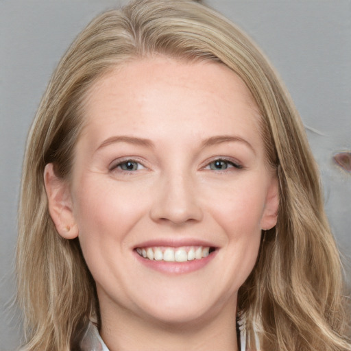 Joyful white young-adult female with long  brown hair and blue eyes