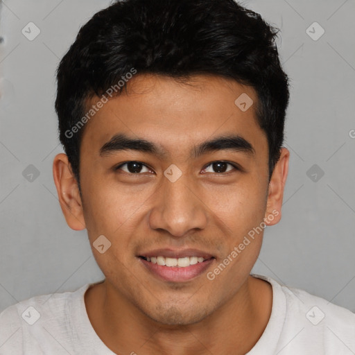 Joyful latino young-adult male with short  brown hair and brown eyes